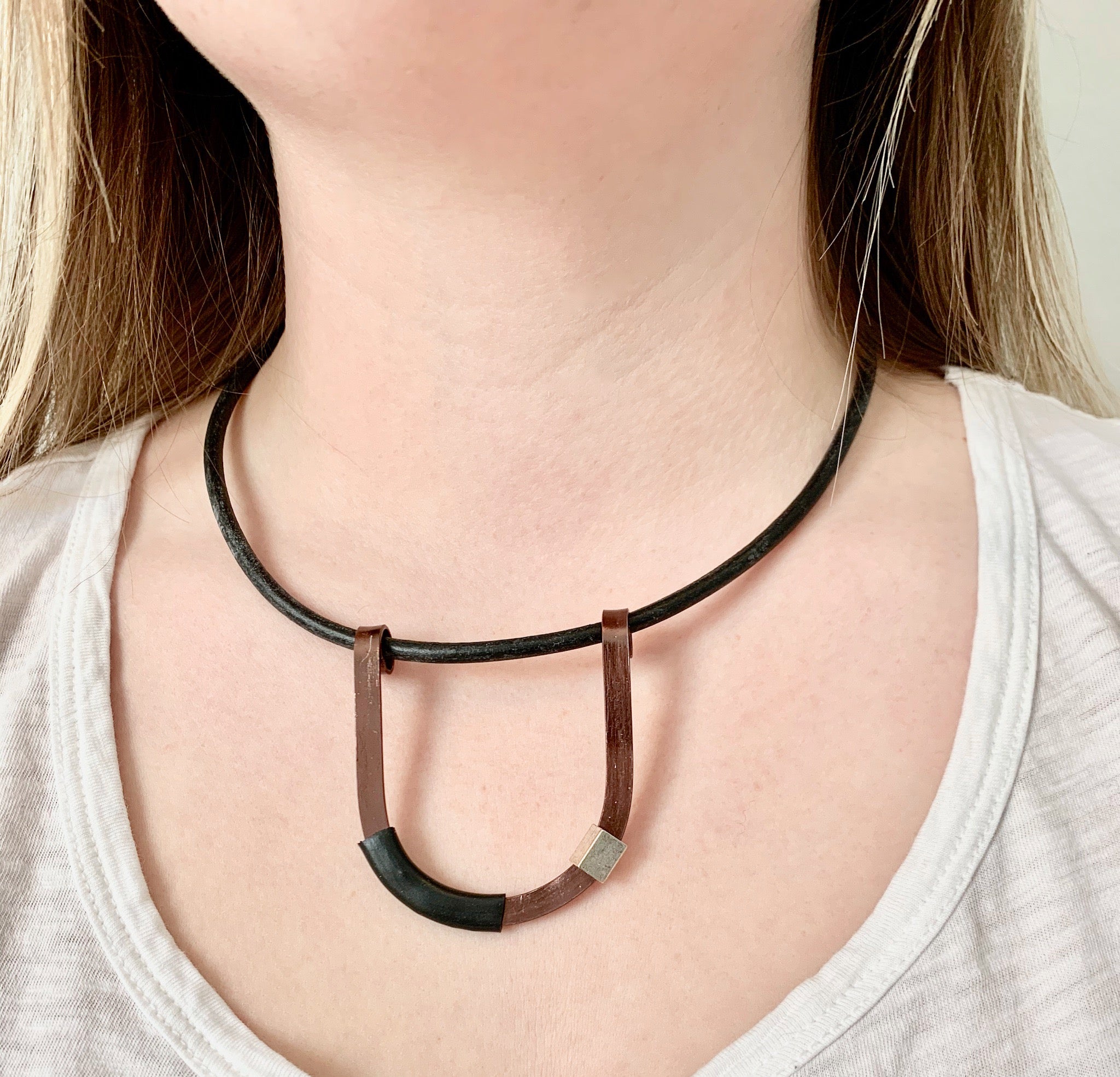 Isabelle is wearing the Bronze with Black Uline on a fine leather cord that hangs 42cm.
