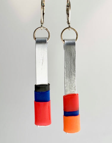 Matchstick earrings in silver coloured aluminum wire with red, orange, royal blue and black coloured silicone tubing. These hang 4.5cm in length.