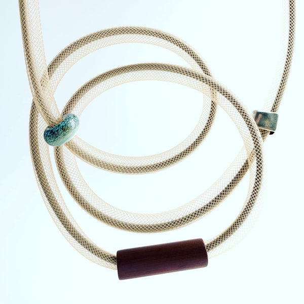 This Tubular is made with beige shock cord and beige netted tubing. it is 115cm.