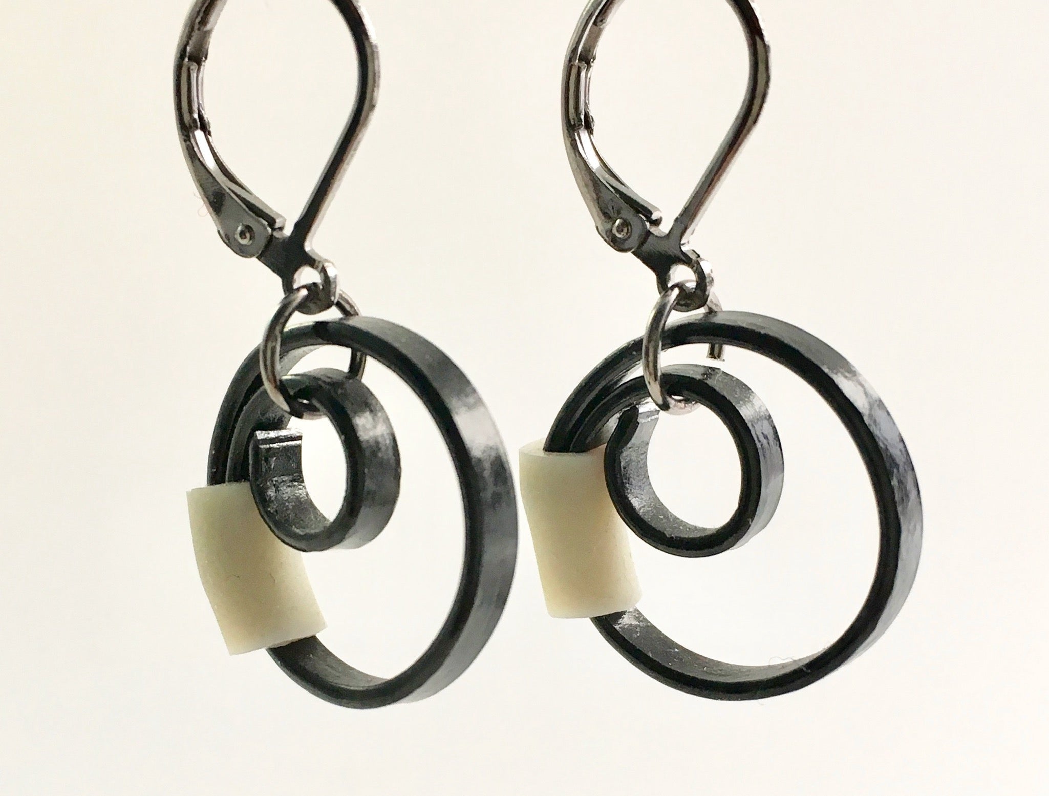 These Reel earrings with a beige accent are a simple fairly small earring that hangs 2cm long.