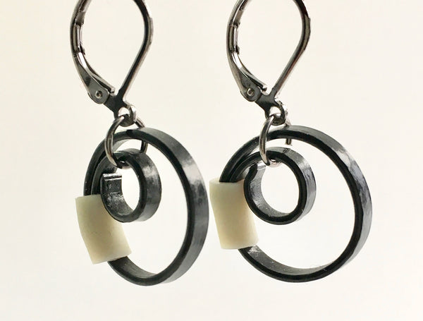 These Reel earrings with a beige accent are a simple fairly small earring that hangs 2cm long.