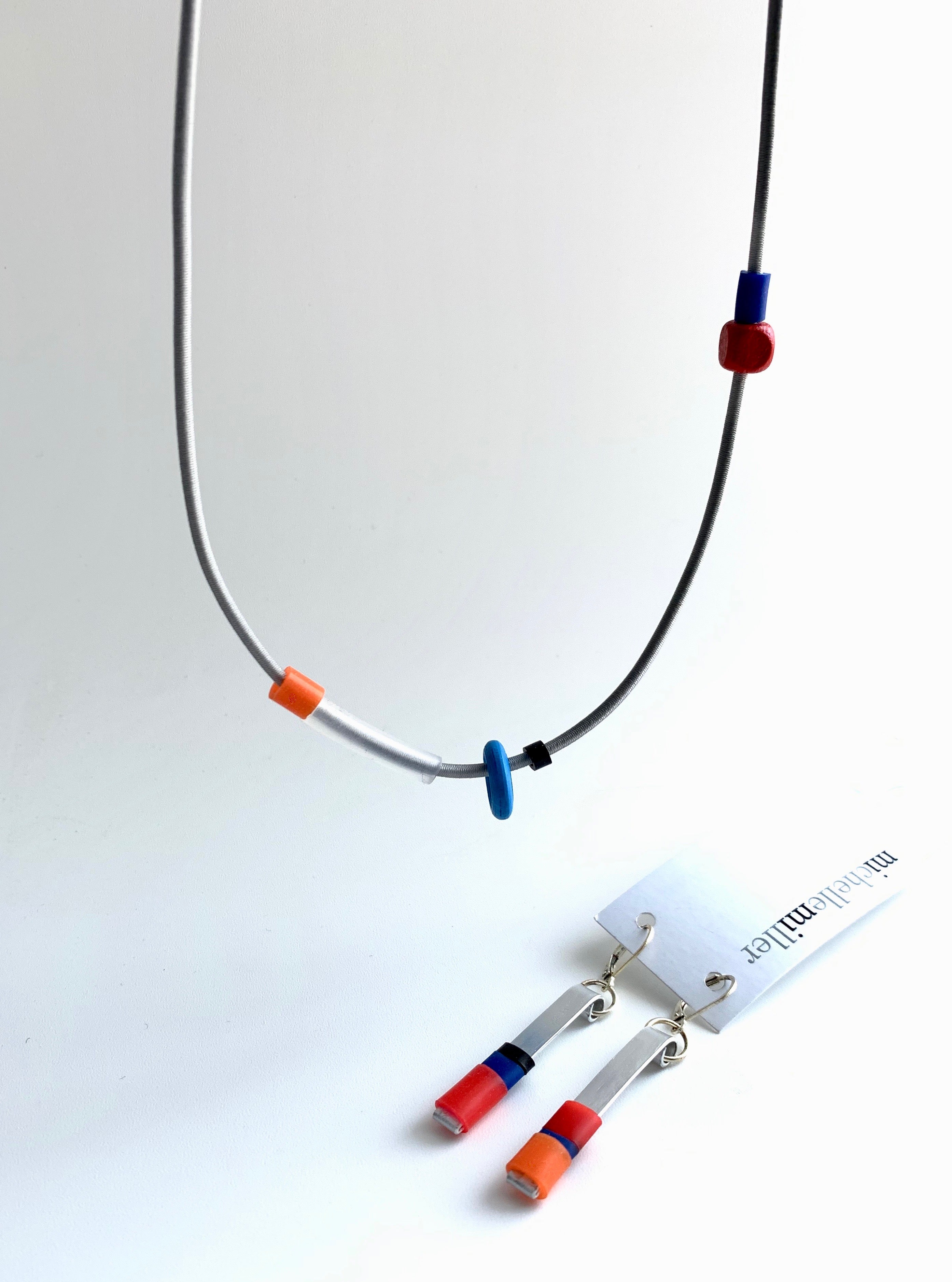 This necklace is made with shock cord silcone and wood  beads. It has an interlocking magnetic clasp and hangs 46cm long. It is paired here with the Matchstick earrings that go best with it. Each sold separately.