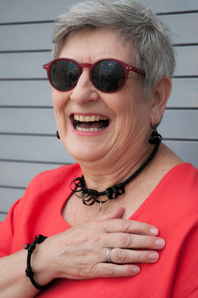 Deb is wearing a Loopt Bracelet in heavy cord with flat black aluminum wire. she is also wearing a Short Loopt Necklace in flat black and Knot earrings, not yet in the store but you can message me if you are interested in.