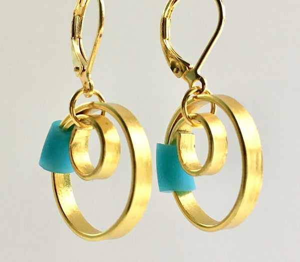 These Reel Earrings are made of gold coloured aluminum wire with added  turq/blue silicone beads. They hang about 2cm in length. All Earrings sport non nickel leverback hooks unless noted otherwise.