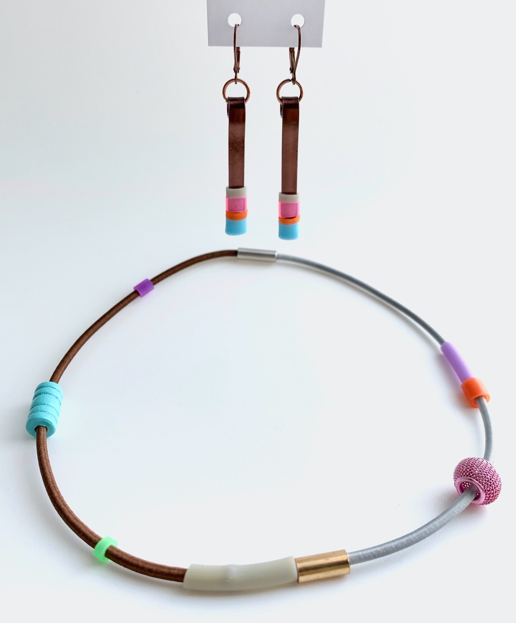 This necklace is made with shock cord silcone, wood and metal beads. It has an interlocking magnetic clasp and hangs 42cm long. This pic also shows Matchstick earrings that pair perfectly with this piece.
