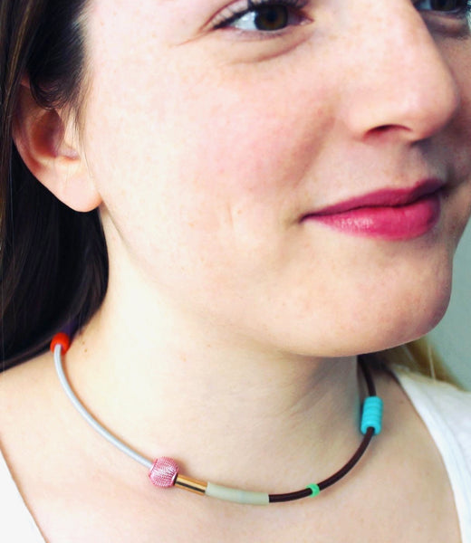 Isabelle wears Colour Collage choker in lt. gray+brown with  pink and turq. beads.