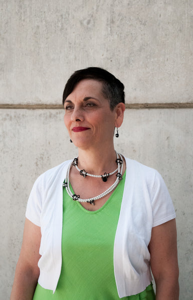 Patricia is wearing Loopt earrings and long Loopt necklace with black round wire.