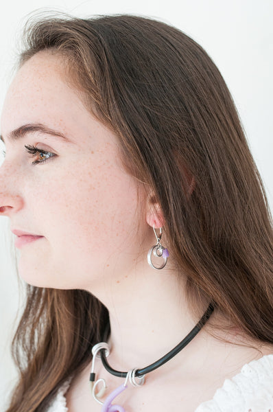 Sadye is wearing Reel earrings in silver with lavender