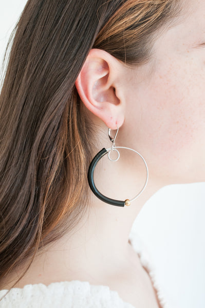 Sadye is wearing Hoopt earrings in flat silver with black and gold. This picture gives you an idea of the size of the hoops even though they are not the same exact earring.