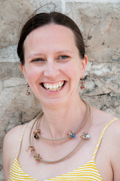 Trista is wearing Loopt earrings and necklace in round copper