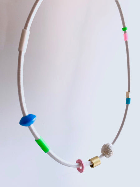This piece is made with 5mm white shock cord and hangs 55cm long.