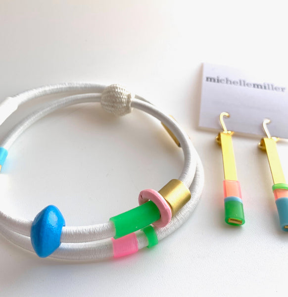 This pic shows the perfect pairing of necklace and earrings as well as shows you the gold magnetic clasp, just under the white cord.