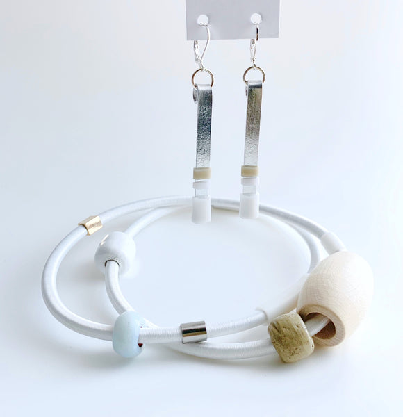 This pic shows the perfect pairing of necklace and earrings. This piece has an interlocking silver magnetic clasp, just under the white cord. You can check on other Colour Block piece.