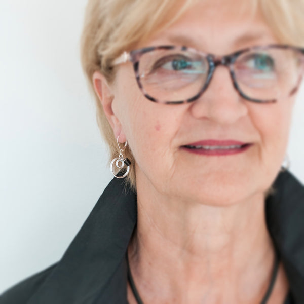 Beverley is wearing the reel earrings in silver with black