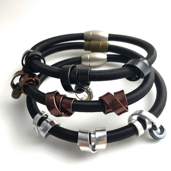 Three Loopt bracelets in heavy cord with flat wire.
