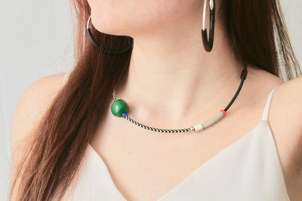 Sadye wears CCC in black and white with big green wooden bead + Hoopt earrings in silver + black