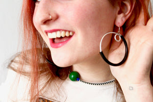 a woman wearing a beautiful black earring