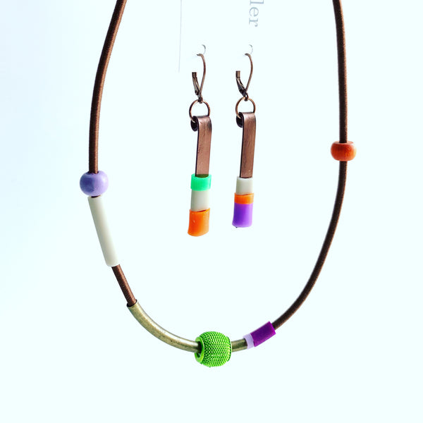 This necklace is made with shock cord silcone, metal and wood beads. It has an interlocking magnetic clasp and hangs 44cm long. This pic also shows the Matchstick earrings that pairs with this piece. Each sold separately.
