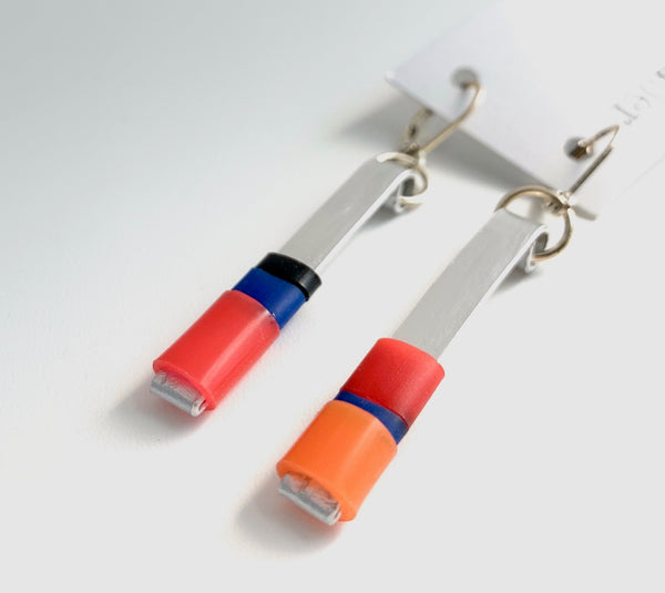 Matchstick earrings in silver coloured aluminum wire with red, orange, royal blue and black coloured silicone tubing. These hang 4.5cm in length.