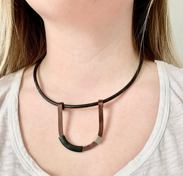 Isabelle is wearing the Bronze with Black Uline on a fine leather cord that hangs 42cm.