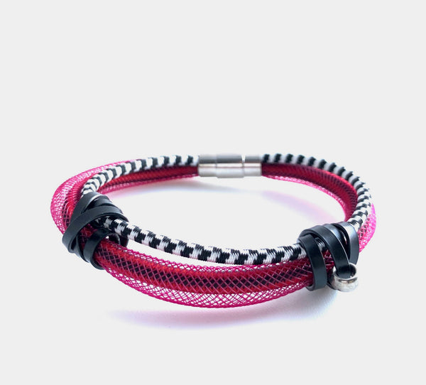 This Bracelet has netted tubing with two different kinds of shock cord and aluminum wire with a magnetic clasp. It is 19cm.