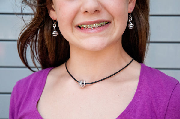 Bella is wearing Loopt earrings and Rubber Loopt necklace both in round silver
