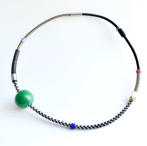 This necklace is made with shock cord silcone, wood and metal beads. It has an interlocking magnetic clasp and hangs 46cm long.