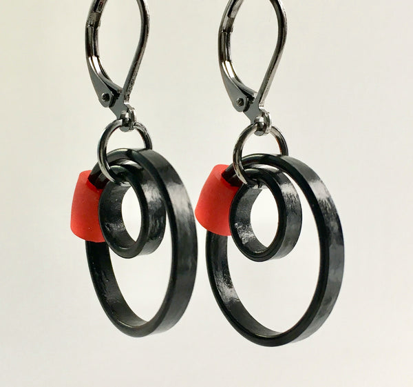 These Reel earrings with a red accent are a simple fairly small earring that hangs 2cm long.