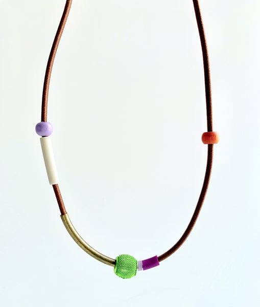 This necklace is made with shock cord silcone, wood and metal beads. It has an interlocking magnetic clasp and hangs 44cm long.
