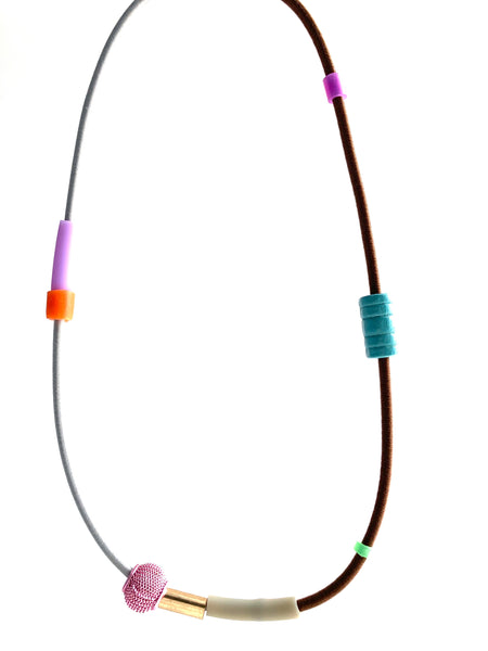 This necklace is made with shock cord silcone, wood and metal beads. It has an interlocking magnetic clasp and hangs 42cm long.