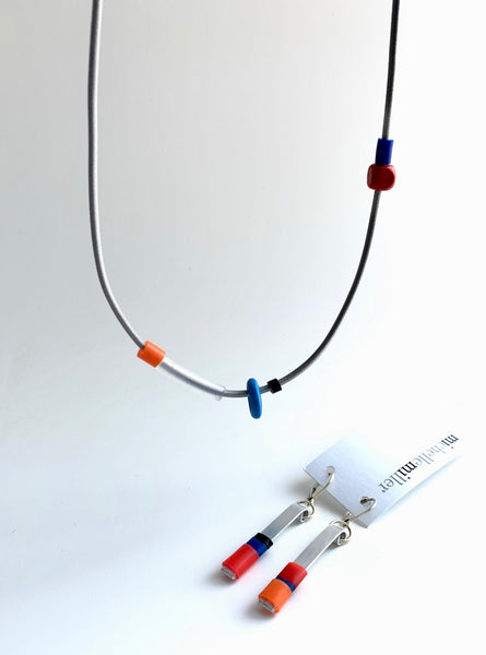 This necklace is made with shock cord silcone and wood  beads. It has an interlocking magnetic clasp and hangs 46cm long. It is paired here with the Matchstick earrings that go best with it. Each sold separately.