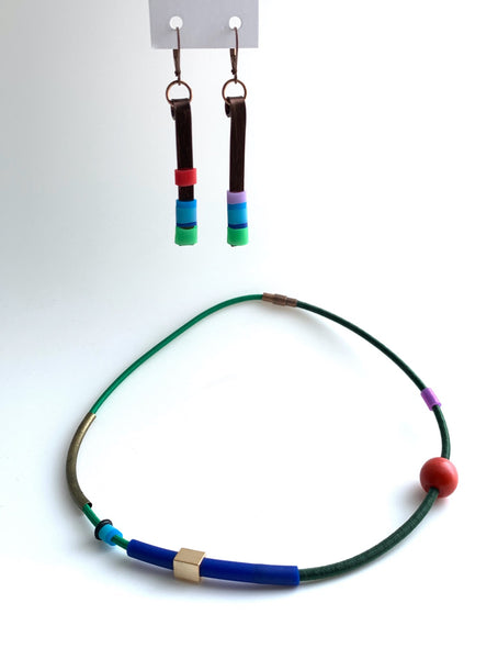 This necklace is made with shock cord silcone, wood and metal beads. It has an interlocking magnetic clasp and hangs 42cm long. This pic shows Matchstick earrings that pair well with this piece.