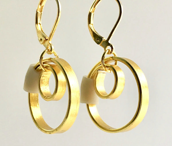 These Reel Earrings are made of gold coloured aluminum wire with added beige silicone beads. They hang about 2cm in length. All Earrings sport non nickel leverback hooks unless noted otherwise.