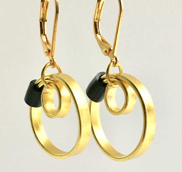 These Reel Earrings are made of gold coloured aluminum wire with added black silicone beads. They hang about 2cm in length. All Earrings sport non nickel leverback hooks unless noted otherwise.