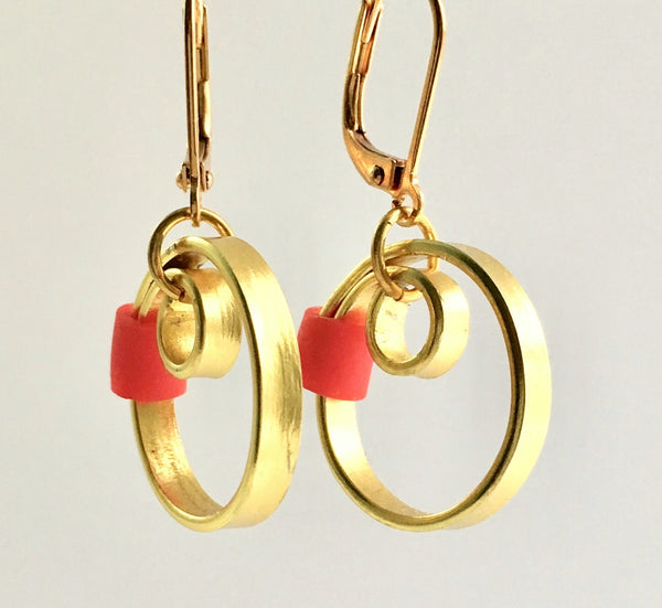 These Reel Earrings are made of gold coloured aluminum wire with added red silicone beads. They hang about 2cm in length. All Earrings sport non nickel leverback hooks unless noted otherwise.