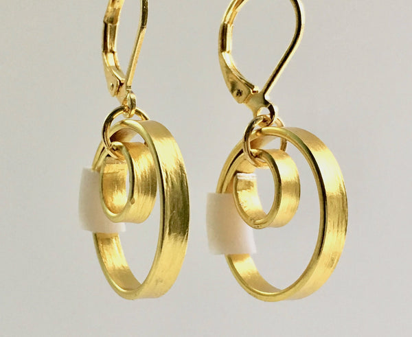 These Reel Earrings are made of gold coloured aluminum wire with added white silicone beads. All Earrings sport non nickel leverback hooks unless noted otherwise.