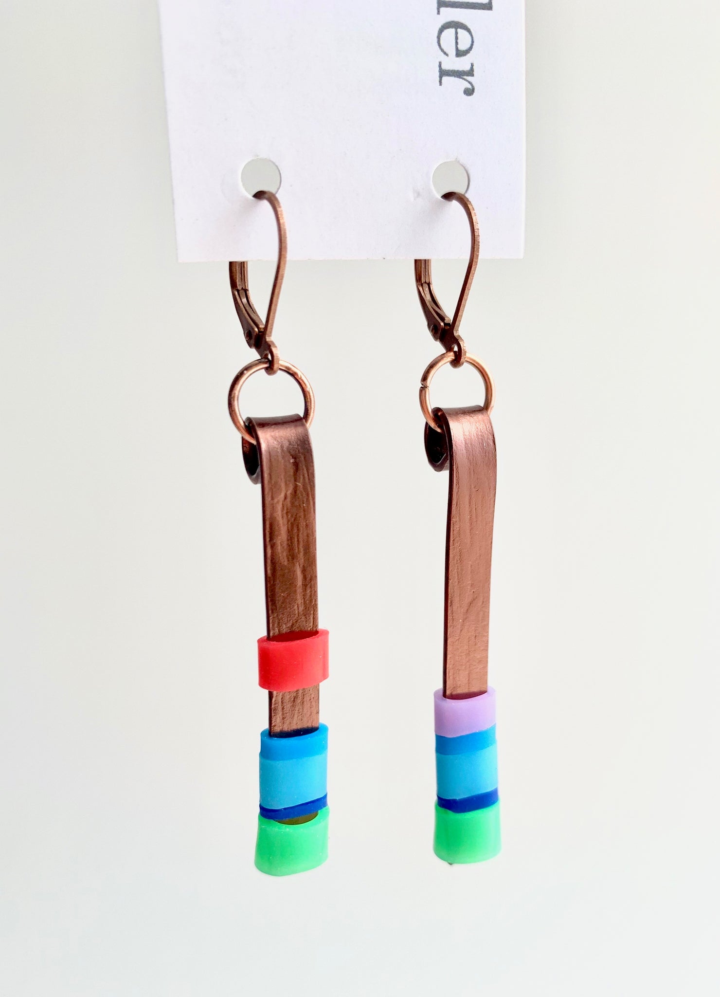 Matchstick earrings in bronze coloured aluminum wire with green, mix of blues, red and lavender coloured silicone tubing. These hang 4.5cm in length.