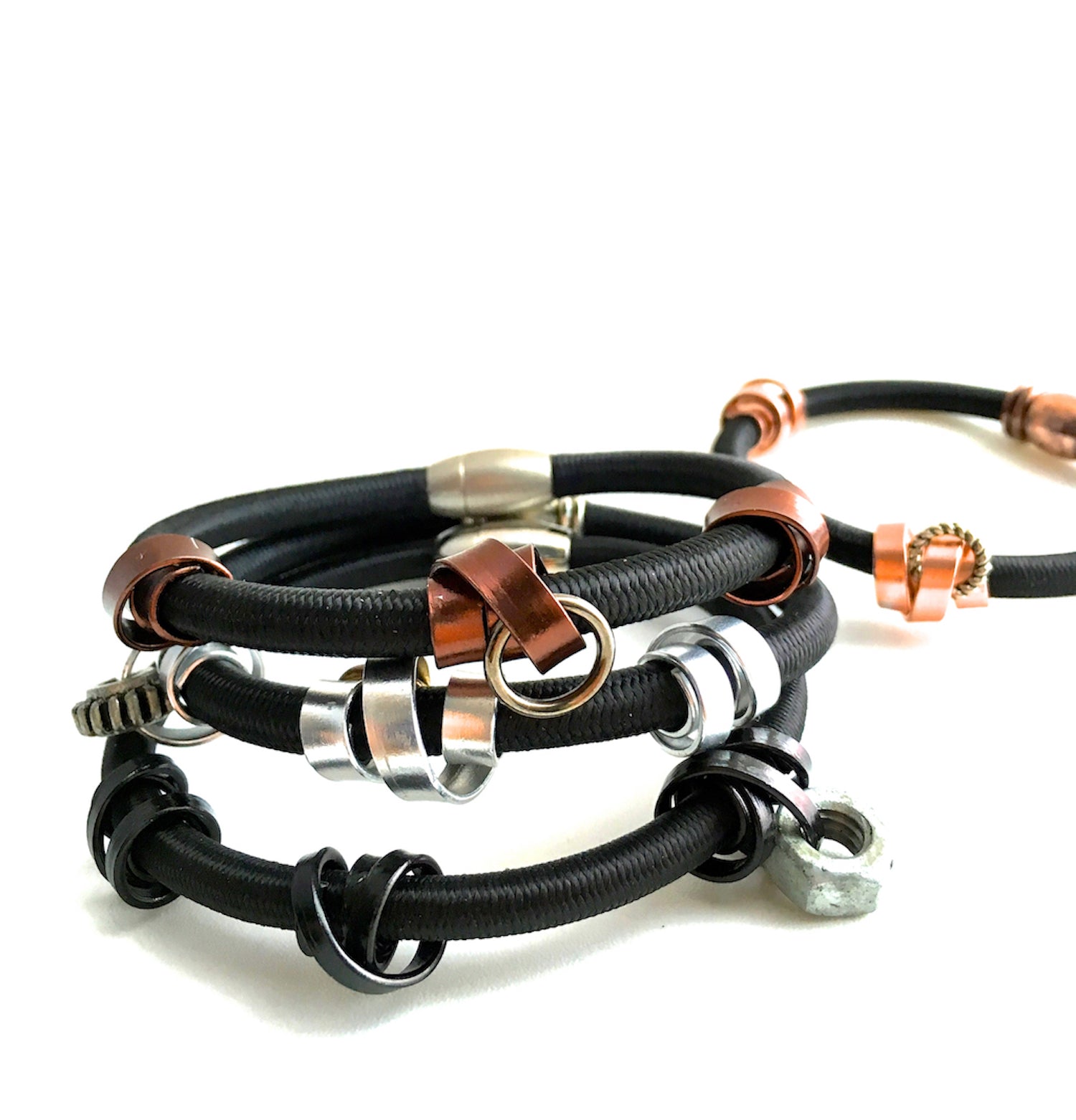 Mix of 4 Loopt bracelets in flat copper, flat bronze, flat silver and thin black on heavy cord.