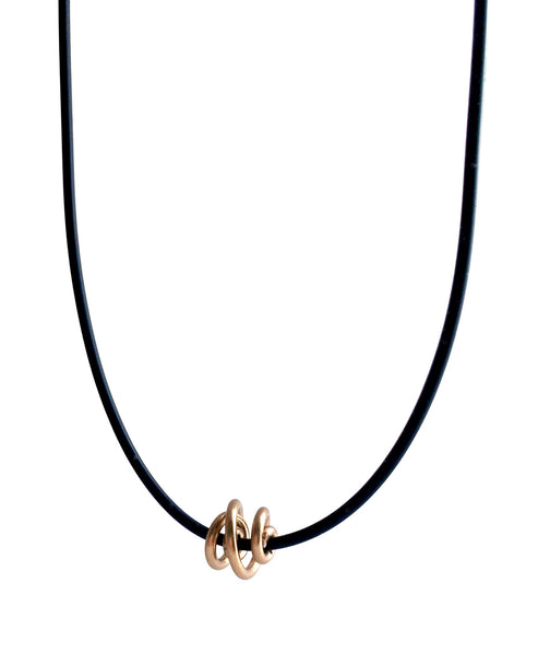 This Rubber Loopt necklace is in round copper. Made of aluminum wire and hangs on a rubber necklace with an interlocking closure. This piece comes in many variations.