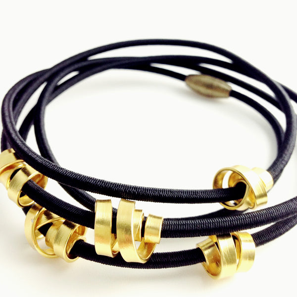 A 112cm Loopt necklace/bracelet in fine black and flat gold coloured aluminum wire.