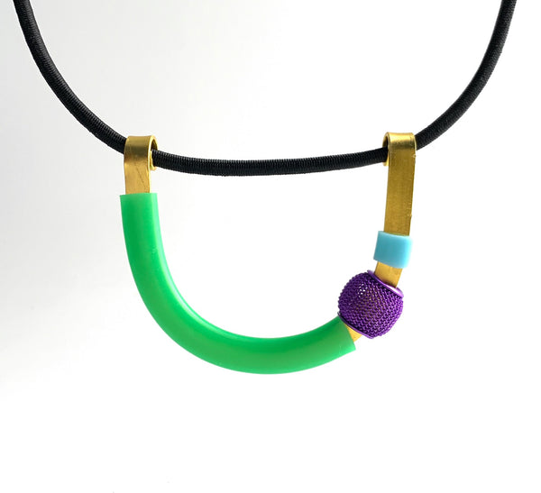 This Uline necklace hangs on a fine black shock cord with a magnetic clasp that is 46cm in length.