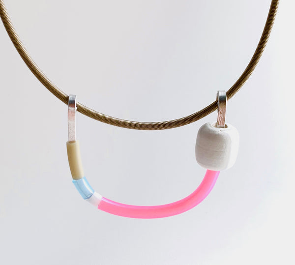 This Uline necklace hangs on a beige shock cord with a magnetic clasp that is 46cm in length.