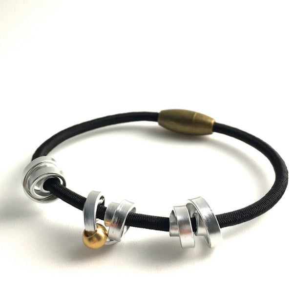 This is a Loopt bracelet on a fine cord and thin silver coloured aluminum wire. All bracelets sport magnetic clasps.