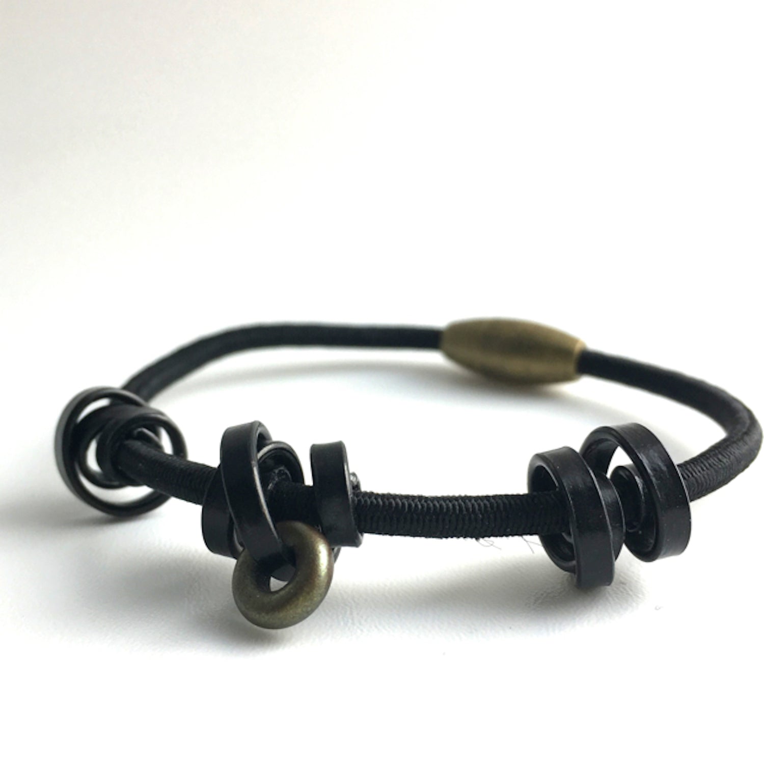 This is a Loopt bracelet on a fine cord and thin black coloured aluminum wire. All bracelets sport magnetic clasps.